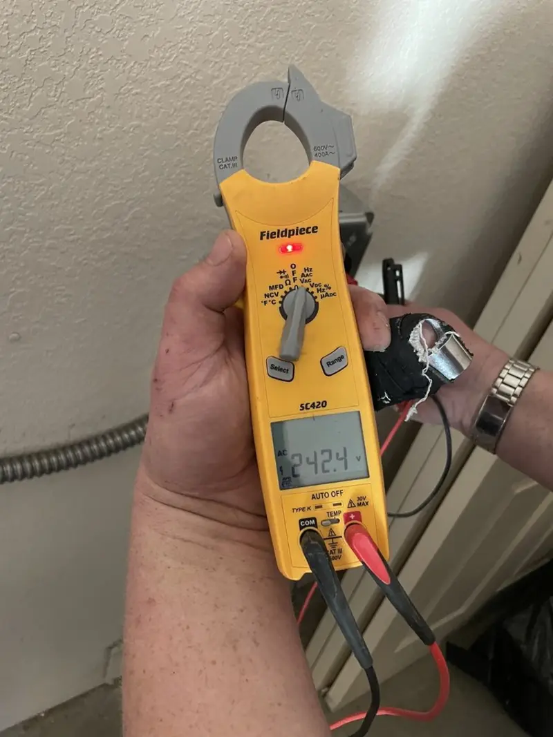Voltage testing with clamp meter during Whole House Surge Protector in Horace